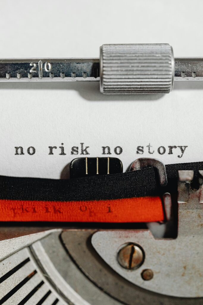 Close-up of a vintage typewriter with a motivational phrase 'no risk no story' typed on paper.